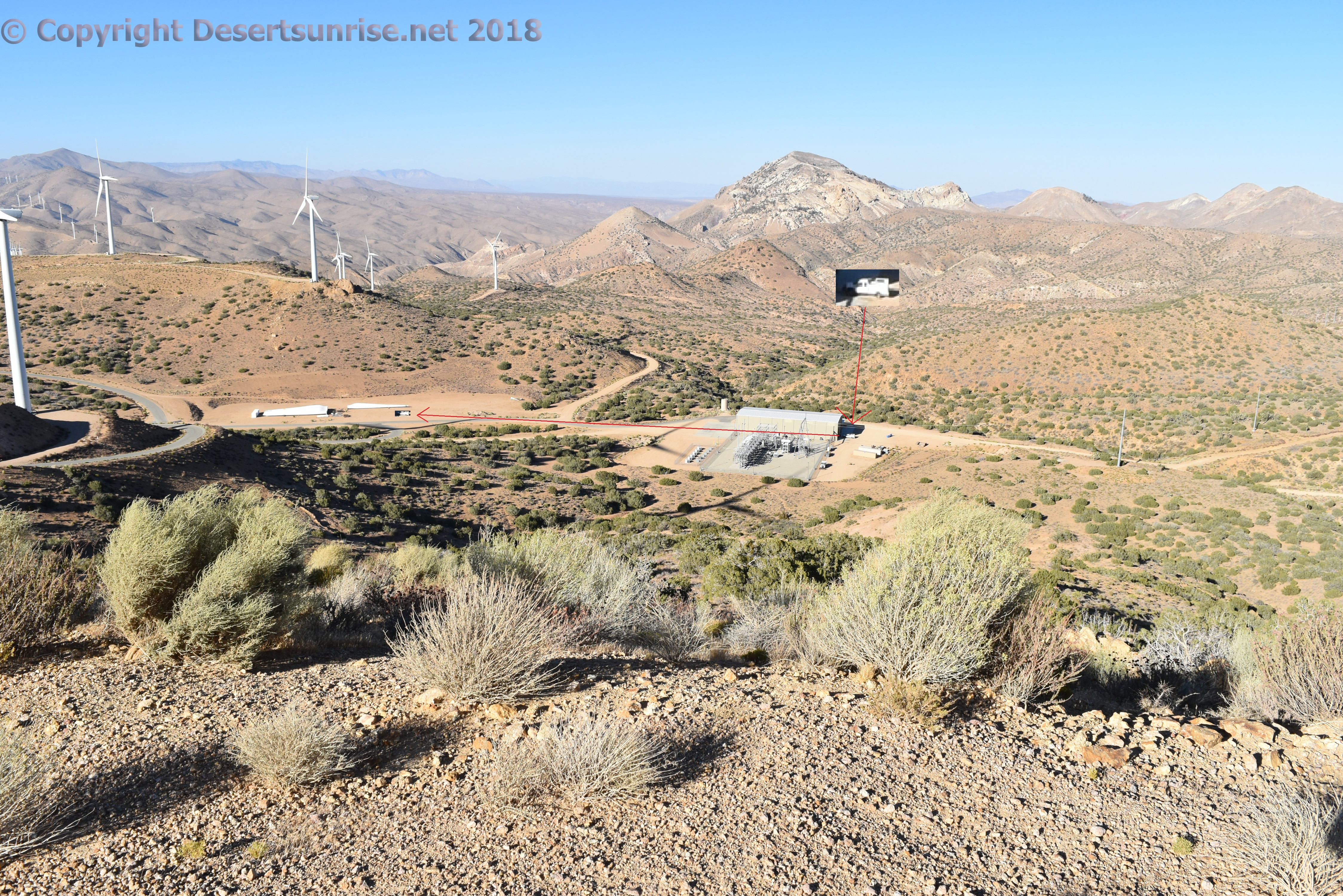 Photo of the O&M area of Pine Tree with a maintenance trucknext to a set of turbine blade transport containers